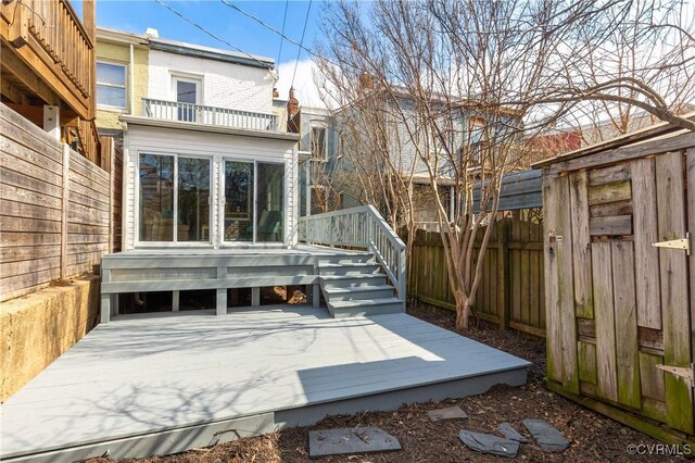 wooden deck featuring a fenced backyard