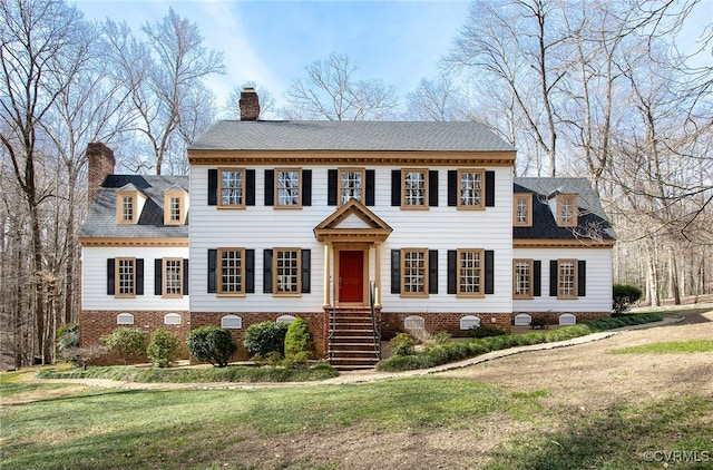 view of front of property featuring a chimney and a front yard