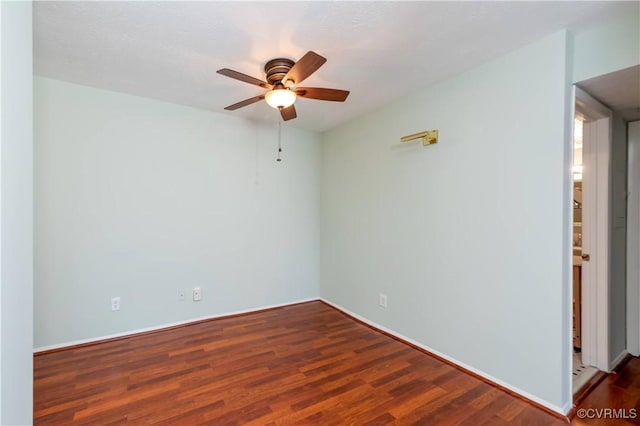 spare room with wood finished floors and a ceiling fan