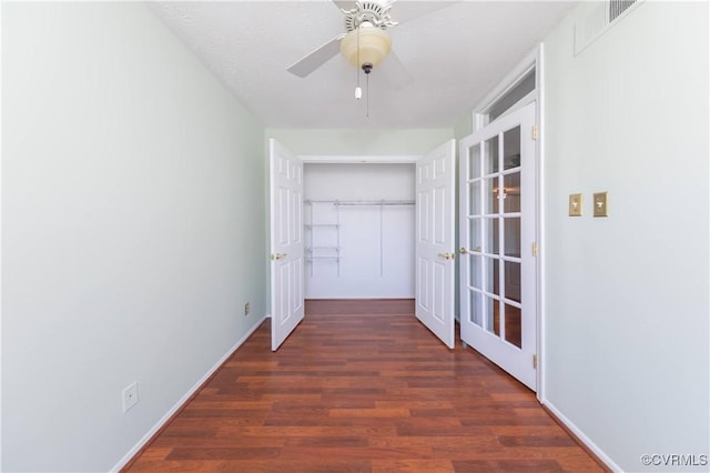 hall featuring baseboards and wood finished floors