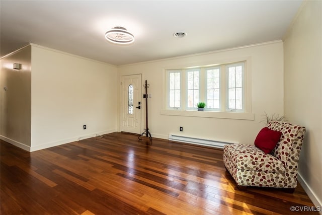 unfurnished room featuring a baseboard heating unit, visible vents, crown molding, and wood finished floors