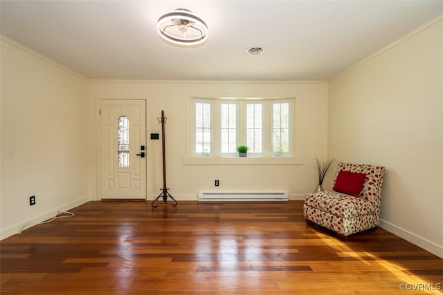 foyer featuring baseboards, ornamental molding, baseboard heating, and wood finished floors