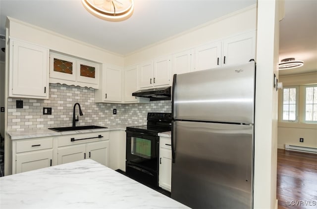 kitchen with under cabinet range hood, electric range, a sink, white cabinetry, and freestanding refrigerator