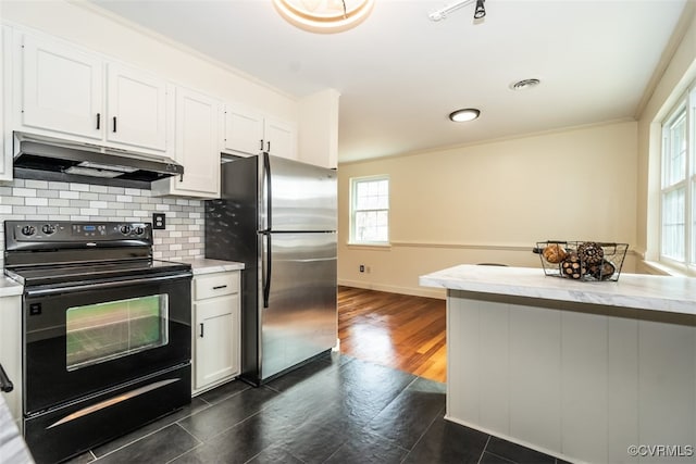 kitchen featuring electric range, tasteful backsplash, freestanding refrigerator, under cabinet range hood, and white cabinetry