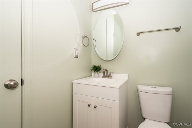 half bathroom with toilet and vanity