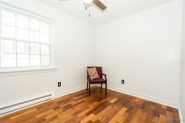 sitting room with a baseboard radiator, baseboards, ceiling fan, and wood finished floors