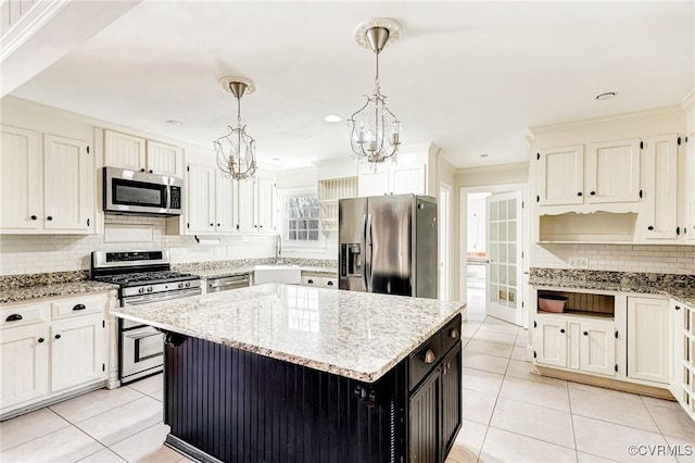 kitchen featuring stainless steel appliances, a center island, light tile patterned floors, and an inviting chandelier