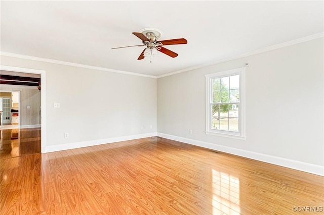 unfurnished room featuring light wood-style floors, ornamental molding, and baseboards