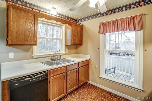 kitchen featuring brick floor, brown cabinets, a sink, dishwasher, and baseboards