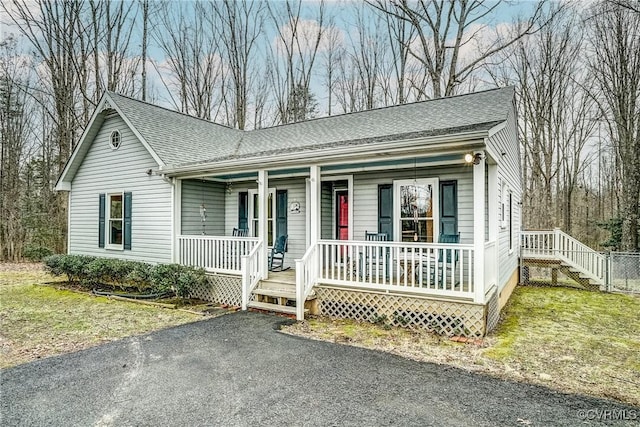 view of front of house with covered porch and roof with shingles