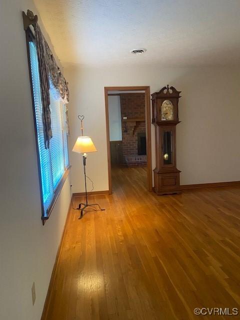 spare room with visible vents, light wood-style flooring, and baseboards