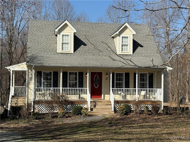 cape cod home with covered porch and a shingled roof