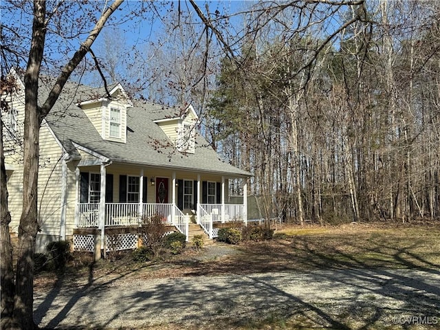 new england style home with covered porch and roof with shingles