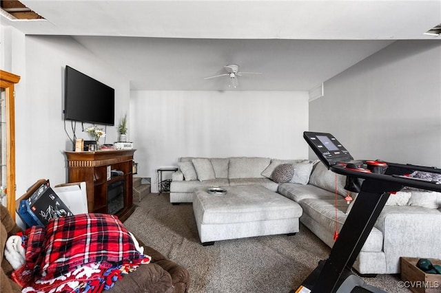 living area featuring a fireplace, ceiling fan, and carpet flooring