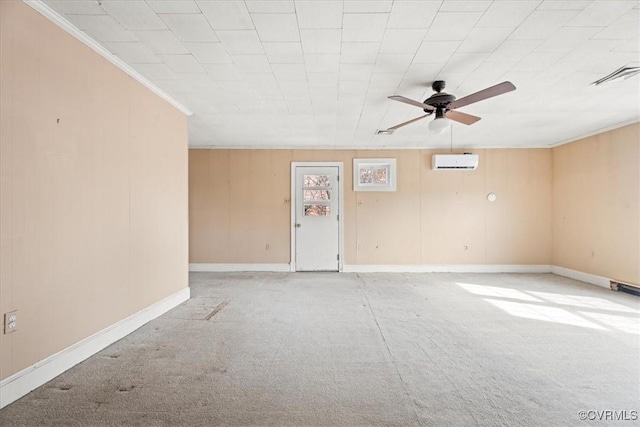 unfurnished room featuring visible vents, baseboards, a wall mounted air conditioner, carpet, and crown molding