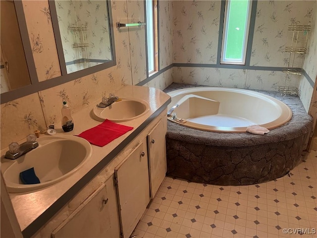 full bath featuring a bath, double vanity, tile patterned floors, and a sink