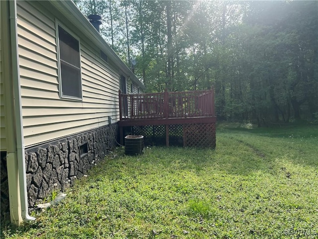 view of yard featuring cooling unit and a deck
