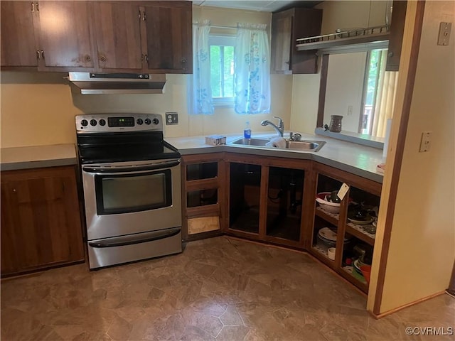 kitchen with stainless steel electric range, under cabinet range hood, a sink, and light countertops