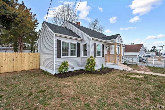 bungalow with a chimney, crawl space, a gate, fence, and a front lawn