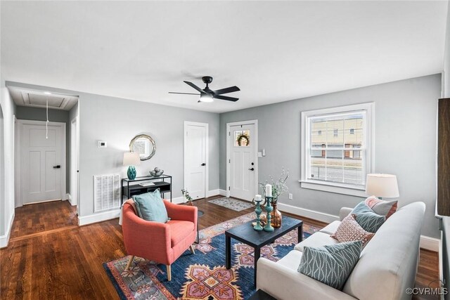 living area featuring attic access, visible vents, and wood finished floors