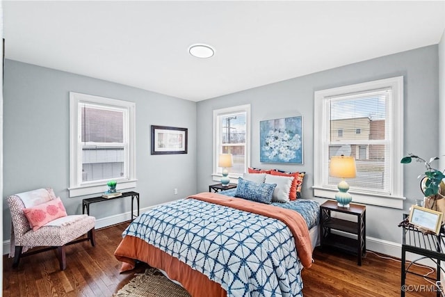 bedroom featuring wood-type flooring and baseboards