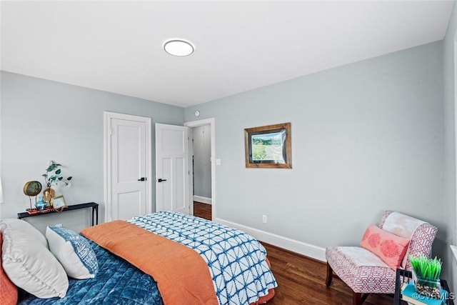 bedroom featuring baseboards and wood finished floors