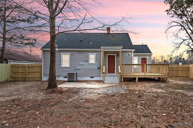 rear view of house featuring crawl space, roof with shingles, fence, and a wooden deck