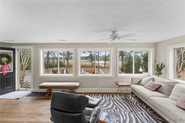 285 Ferry Landing Rd, Dunnsville, VA 22454 - living room featuring hardwood / wood-style flooring, baseboards, a ceiling fan, and a textured ceiling