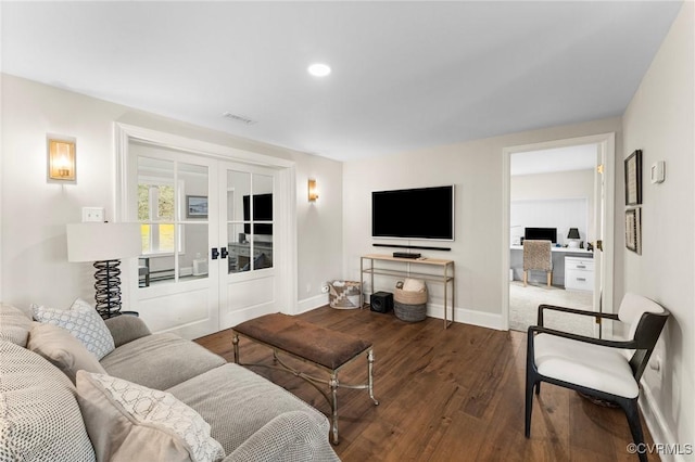 living room with visible vents, baseboards, wood finished floors, and french doors