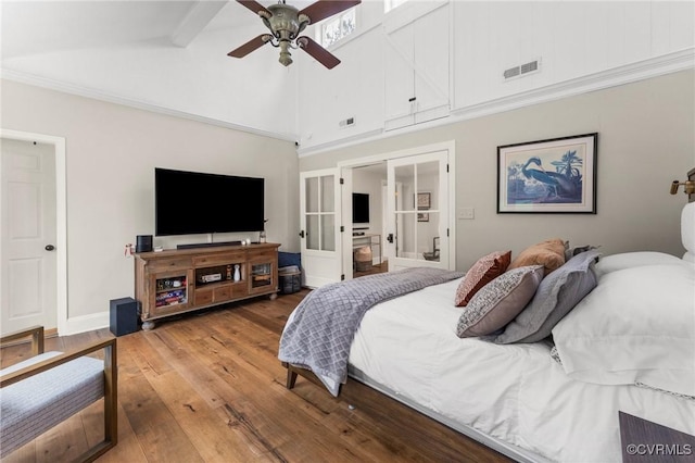 bedroom with high vaulted ceiling, wood-type flooring, visible vents, and baseboards