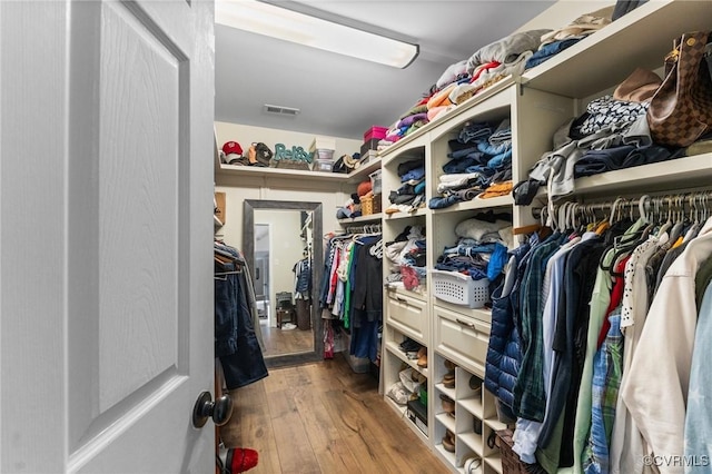 spacious closet featuring visible vents and hardwood / wood-style floors