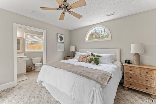 bedroom with multiple windows, visible vents, and light colored carpet