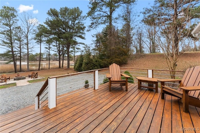 wooden terrace featuring an outdoor fire pit