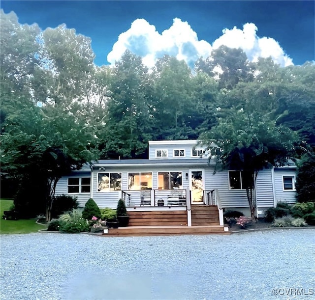 rear view of house featuring a wooden deck