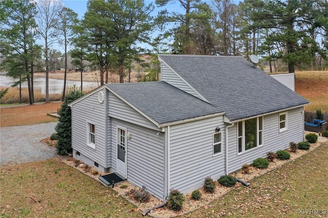 view of side of home with roof with shingles