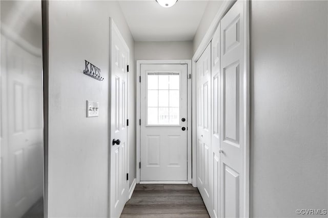 doorway with dark wood-type flooring