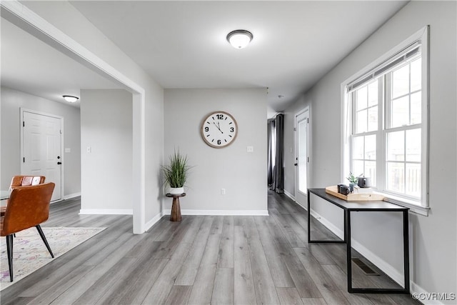 foyer entrance with wood finished floors and baseboards