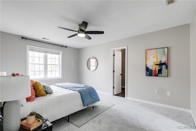 carpeted bedroom with visible vents, ceiling fan, and baseboards