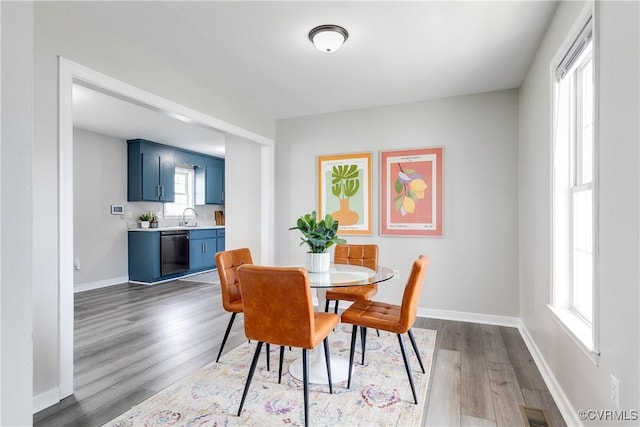 dining area featuring visible vents, baseboards, and wood finished floors