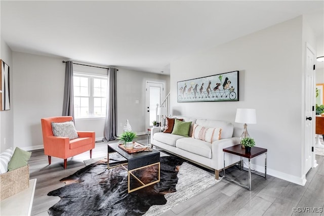 living room with baseboards and wood finished floors