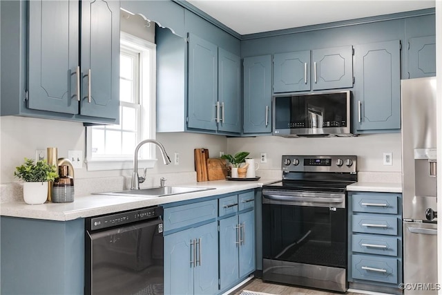 kitchen with a sink, light countertops, and stainless steel appliances