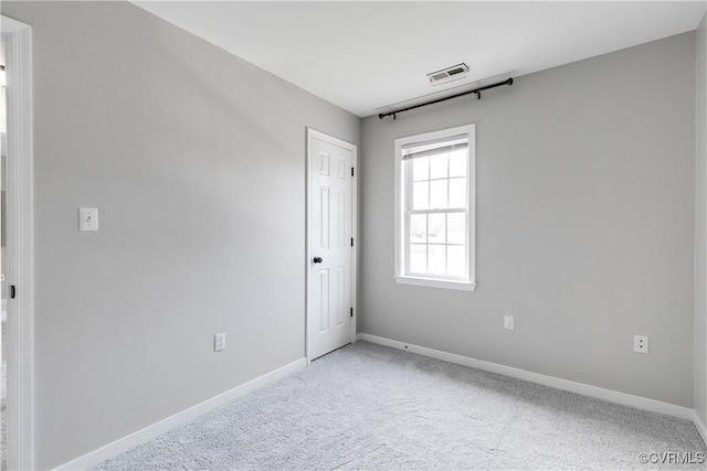 spare room featuring visible vents, baseboards, and carpet floors