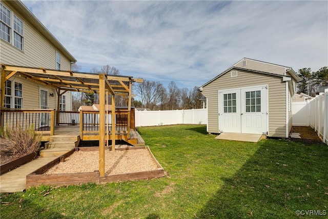 view of yard featuring an outbuilding, a fenced backyard, a pergola, a storage unit, and a deck