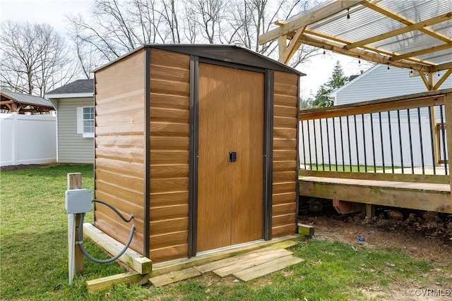 view of shed featuring fence