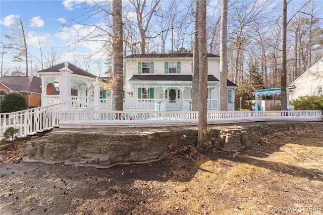 view of front of house with a porch and fence