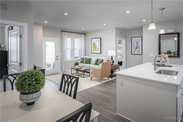 dining area featuring wood finished floors, visible vents, and recessed lighting