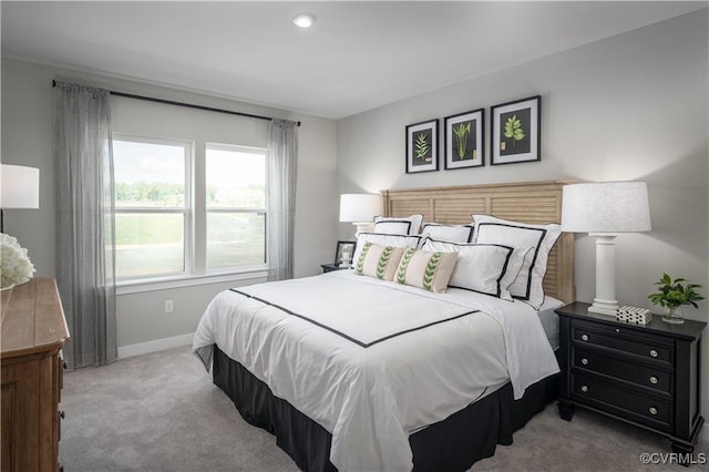 carpeted bedroom featuring baseboards