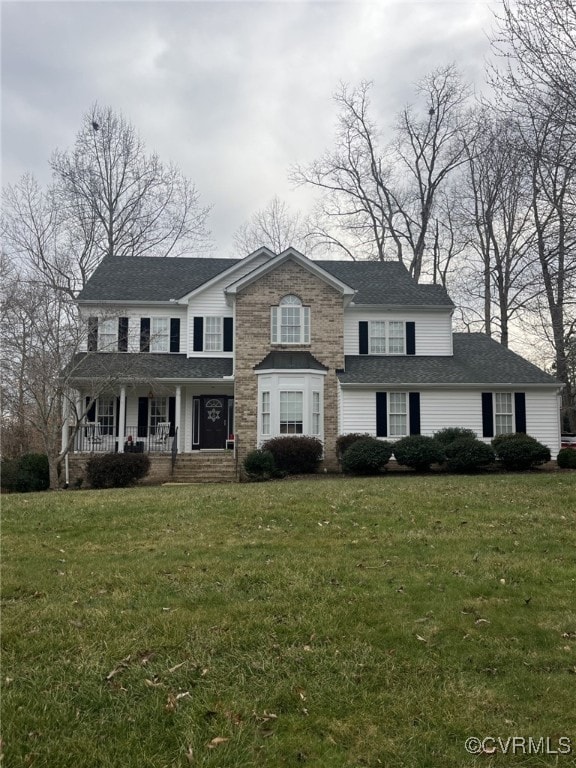 view of front of home featuring a porch and a front lawn