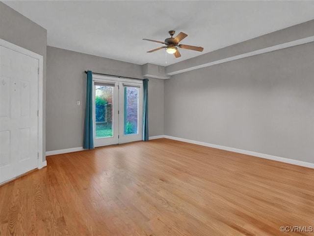 unfurnished room with light wood-style floors, baseboards, and a ceiling fan