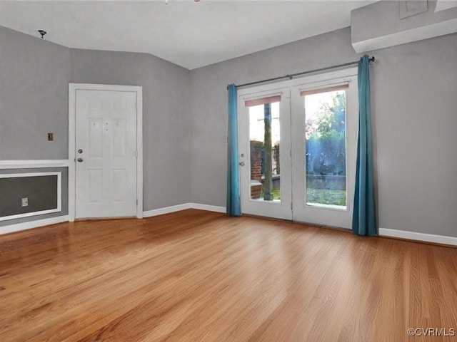 interior space featuring baseboards and wood finished floors